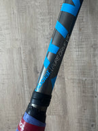 A close-up of a pre-owned Babolat Pure Drive VS 4 3/8 tennis racquet for advanced players, seen resting on a wooden floor.